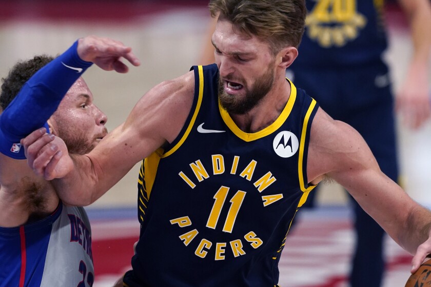 Indiana Pacers forward Domantas Sabonis (11) runs into the defense of Detroit Pistons forward Blake Griffin during the first half of an NBA basketball game, Thursday, Feb. 11, 2021, in Detroit. (AP Photo/Carlos Osorio)