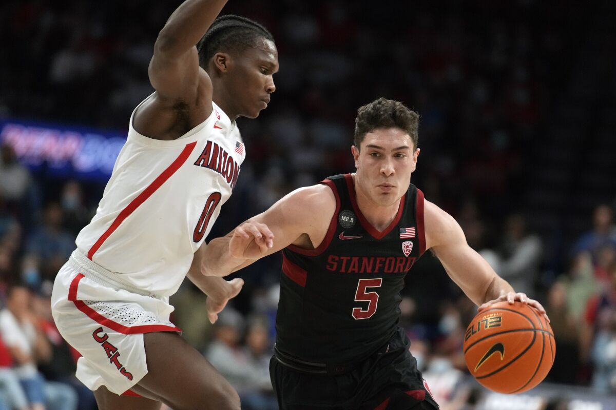 Stanford guard Michael O'Connell (5) drives on Arizona guard Bennedict Mathurin during the first half of an NCAA college basketball game Thursday, March 3, 2022, in Tucson, Ariz. (AP Photo/Rick Scuteri)