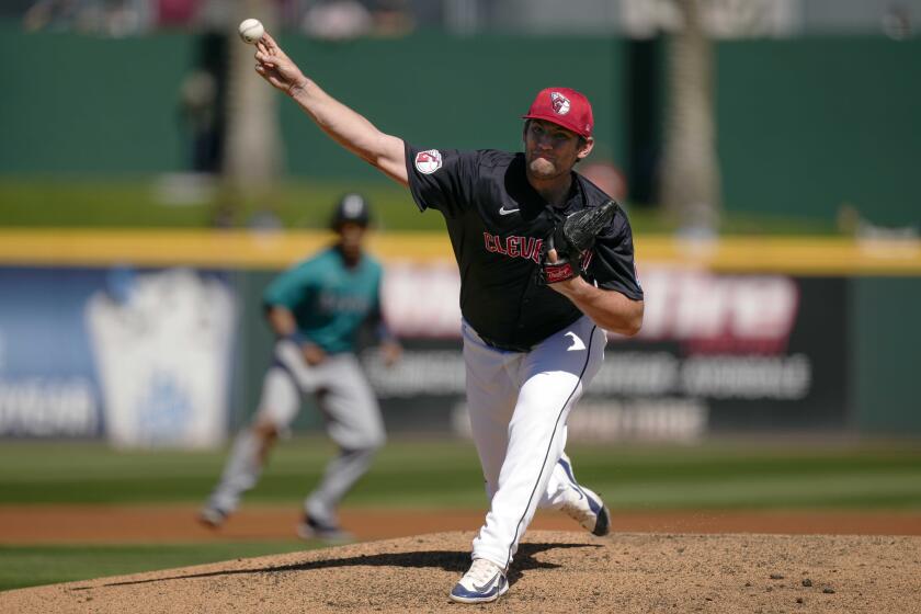 FILE - Cleveland Guardians starting pitcher Gavin Williams throws during the first inning of a spring training baseball game against the Seattle Mariners on Tuesday, March 5, 2024, in Goodyear, Ariz. Williams has suffered a setback in his recovery from an elbow injury and will be shut down for at least another week. (AP Photo/Carolyn Kaster, File)
