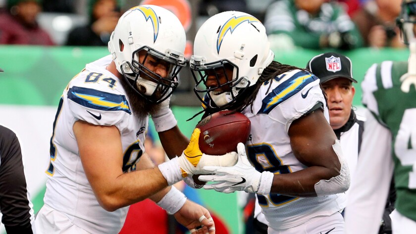 Tight end Sean McGrath (84) and running back Melvin Gordon celebrate after the Chargers scored a touchdown against the Jets on Sunday.