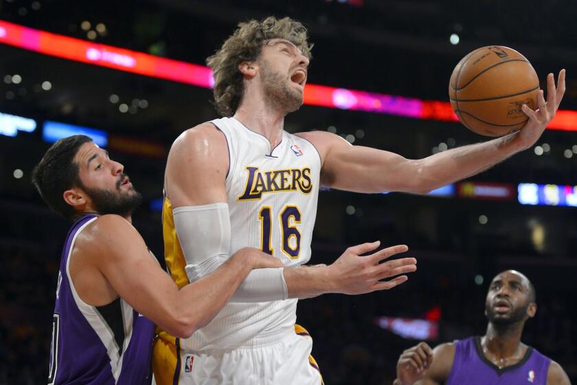 Lakers power forward Pau Gasol gets a shot inside despite the hands-on defense of Kings guard Greivis Vasquz in the first half Sunday evening at Staples Center.
