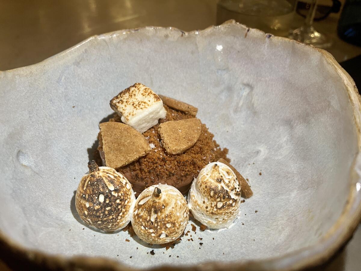 A plate of deconstructed s'mores with torched marshmallows