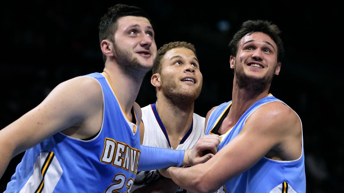 Clippers forward Blake Griffin, center, is blocked out by Denver Nuggets teammates Jusuf Nurkic, left, and Danilo Gallinari during a game at Staples Center on Jan. 26.