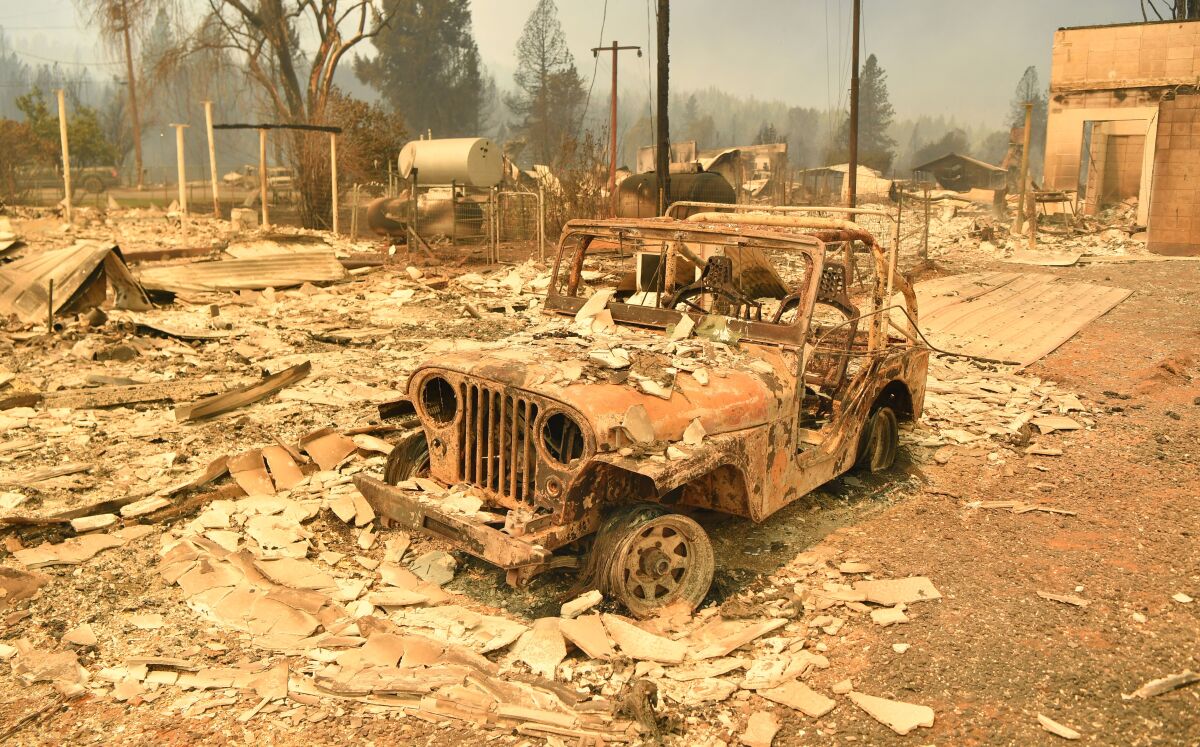 A burned Jeep  in a decimated downtown Greenville, Calif., during the Dixe fire