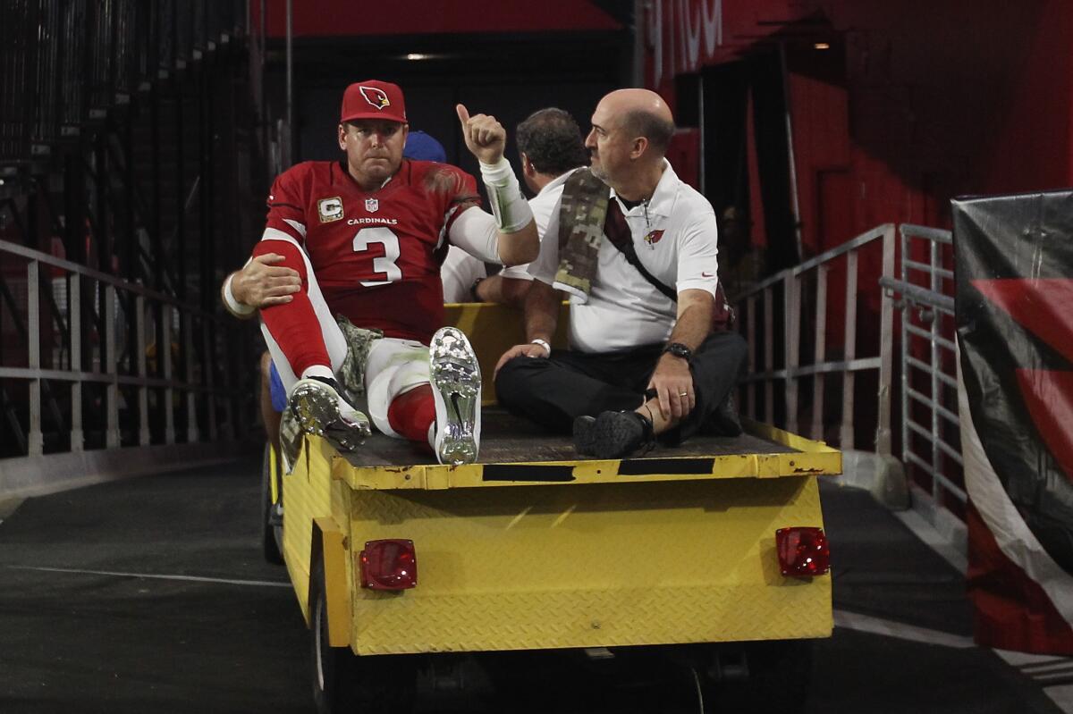 Arizona quarterback Carson Palmer is taken off the field after being injured in the fourth quarter Sunday against the St. Louis Rams.