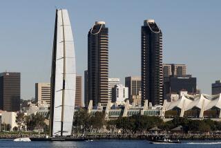 ** ADVANCE FOR WEEKEND EDITIONS, FEB. 6-7 ** In this photo taken on Wednesday, Nov. 25, 2009, The BMW Oracle trimaran sails past the San Diego skyline during testing in San Diego. The trimaran, with it's 190 foot fixed wing sail, races against America's Cup defending champion, Alinghi of Switzerland, beginning Monday in Spain. (AP Photo/Lenny Ignelzi)