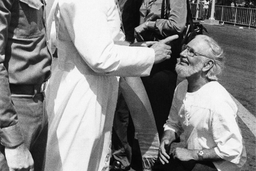 Daniel Ortega flanks Pope John Paul II who wags his finger at Ernesto Cardenal during welcoming ceremonies at the airport in Managua, Nicaragua in 1983.