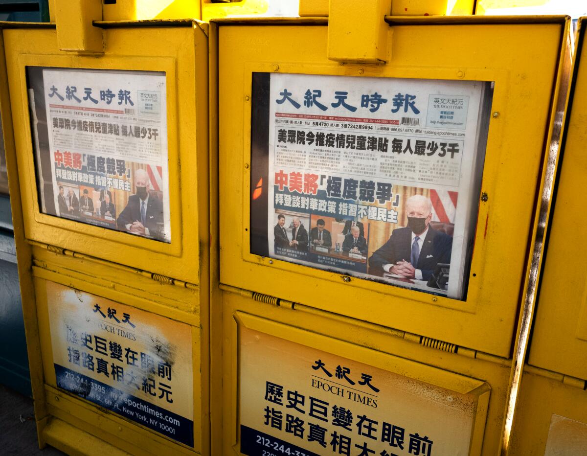 Epoch Times copies for sale in sidewalk newspaper boxes in New York