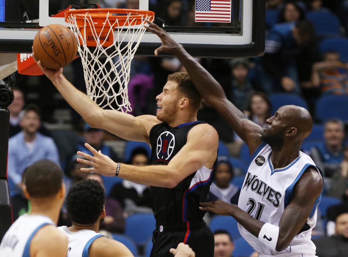 Blake Griffin of the Clippers goes for a reverse layup against Kevin Garnett of the Timberwolves on Monday night.