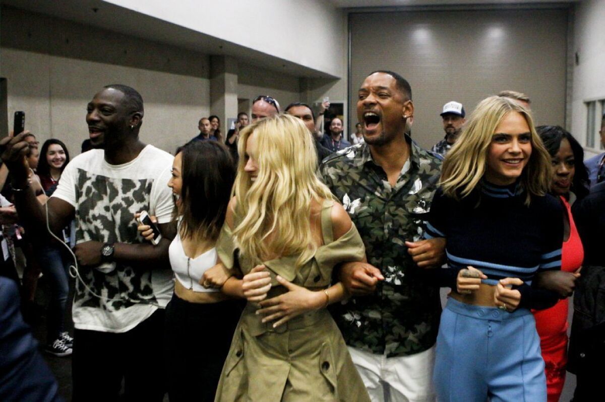 "Suicide Squad" cast members -- from left, Adewale Akinnuoye-Agbaje, Karen Fukuhara, Margot Robbie, Will Smith, Cara Delevingne and Viola Davis -- arrive at an autograph signing session at Comic-Con.