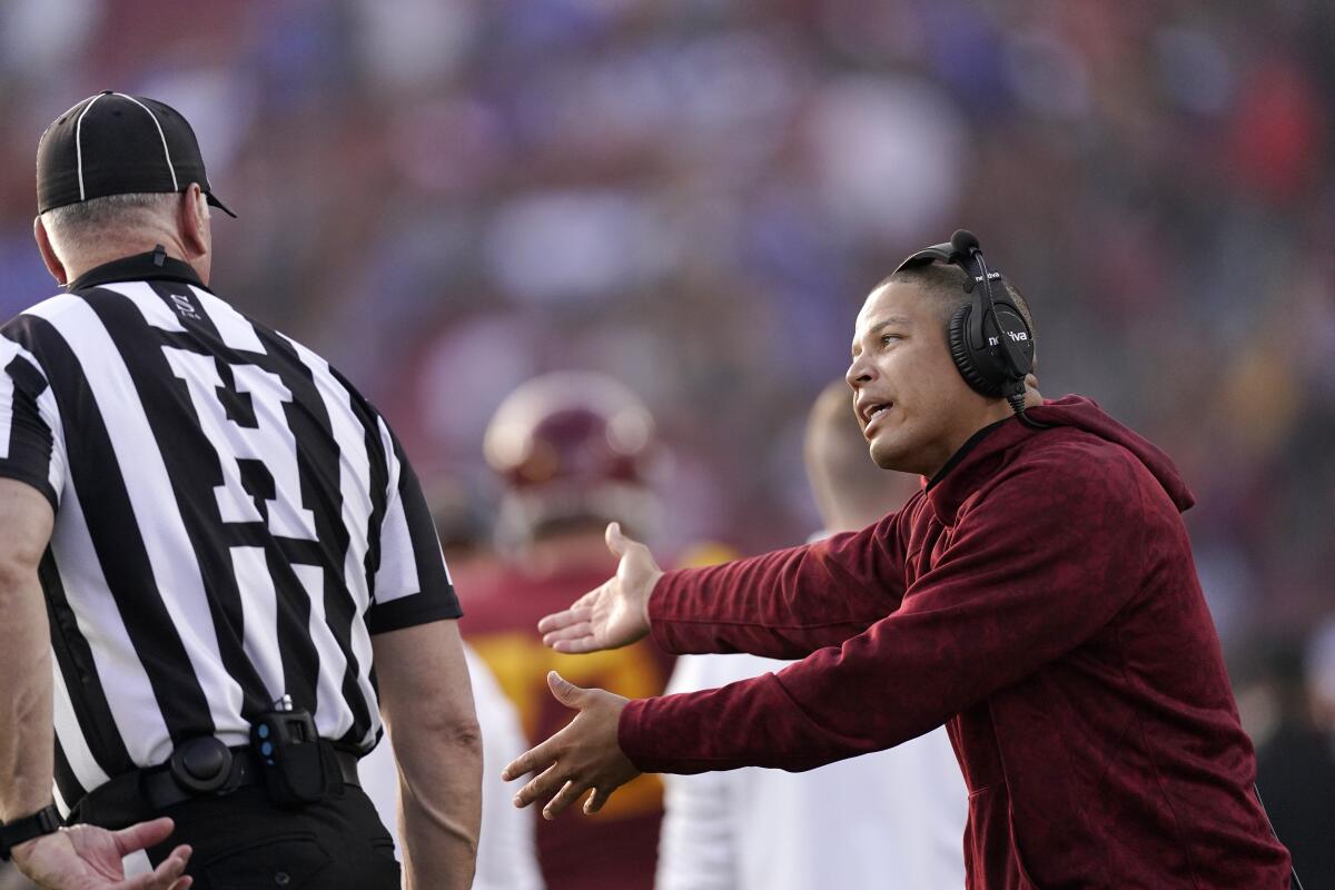 USC interim head coach Donte Williams talks to an official during the second half of the Trojans' loss to UCLA.