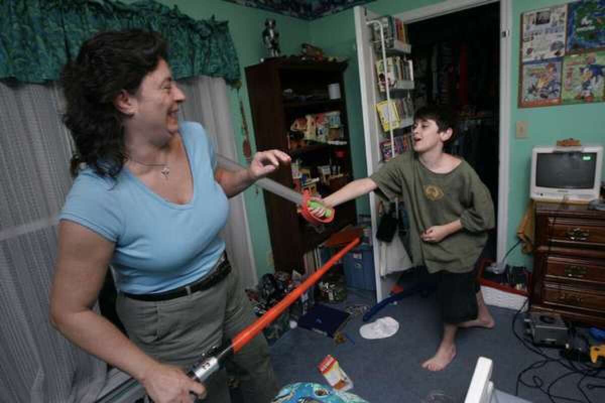 Julia Massey and son Ryan Massey, 11, right, play in his room at their Georgia home in 2007. Ryan is the youngest of three brothers in his family, all of whom have Asperger's syndrome, a milder variant of autistic spectrum disorder.