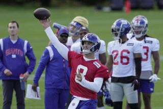 El quarterback Daniel Jones (8), de los Giants de Nueva York, participa en la sesión de entrenamiento en Ware, Inglaterra, el viernes 7 de octubre de 2022. (AP Foto/Kin Cheung)