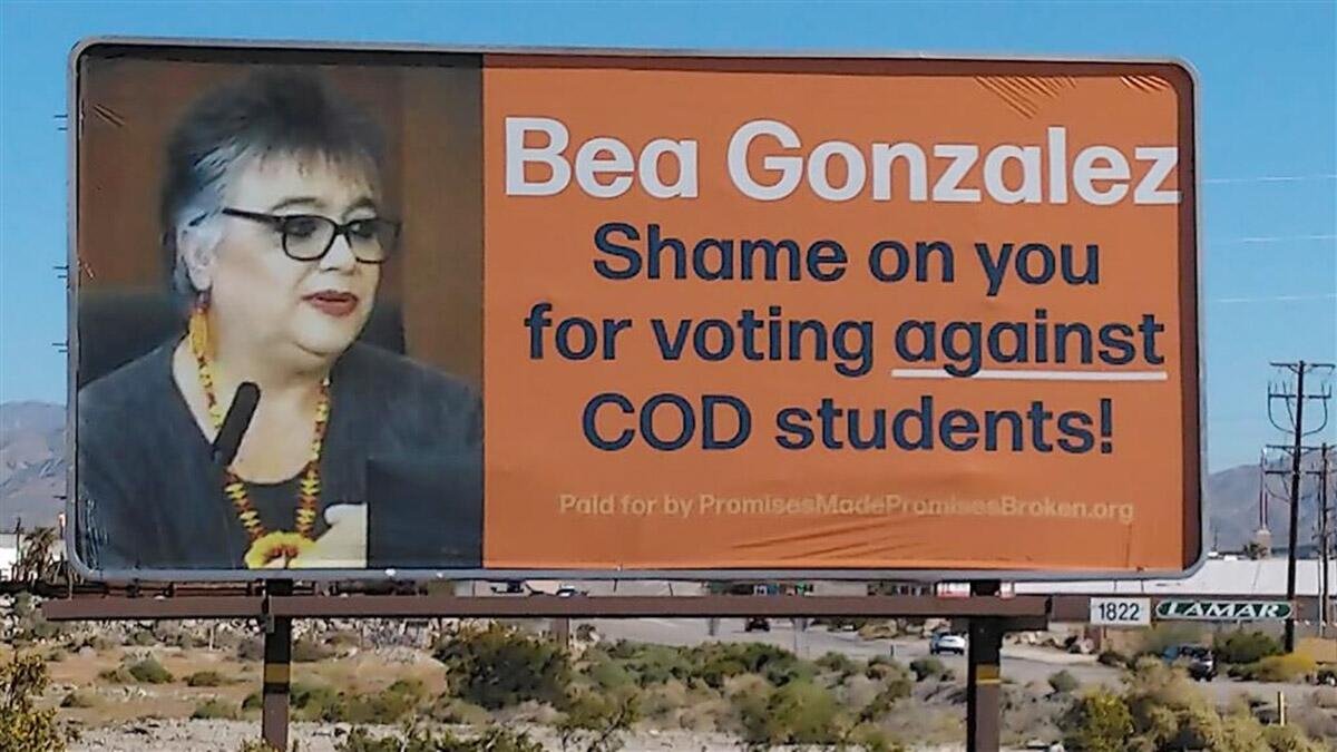 A billboard shows a photo of a woman and the words "Bea Gonzalez, shame on you for voting against COD students!"