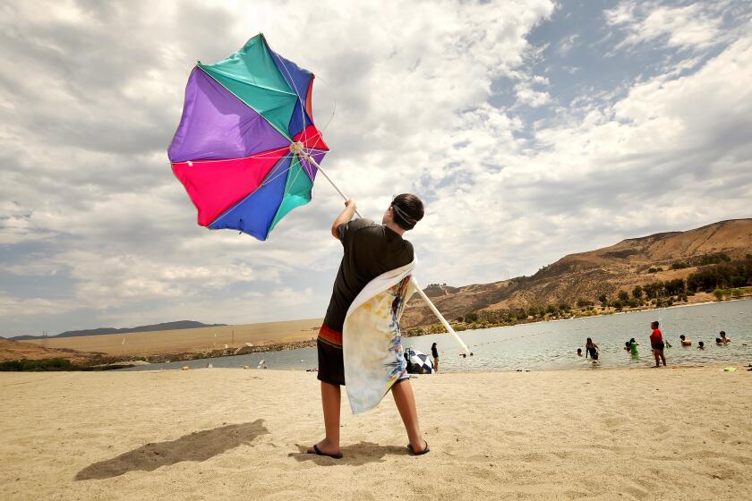 CASTAIC, CA - JULY 08: Zachary Pruett, 10, catches wind with this umbrella 