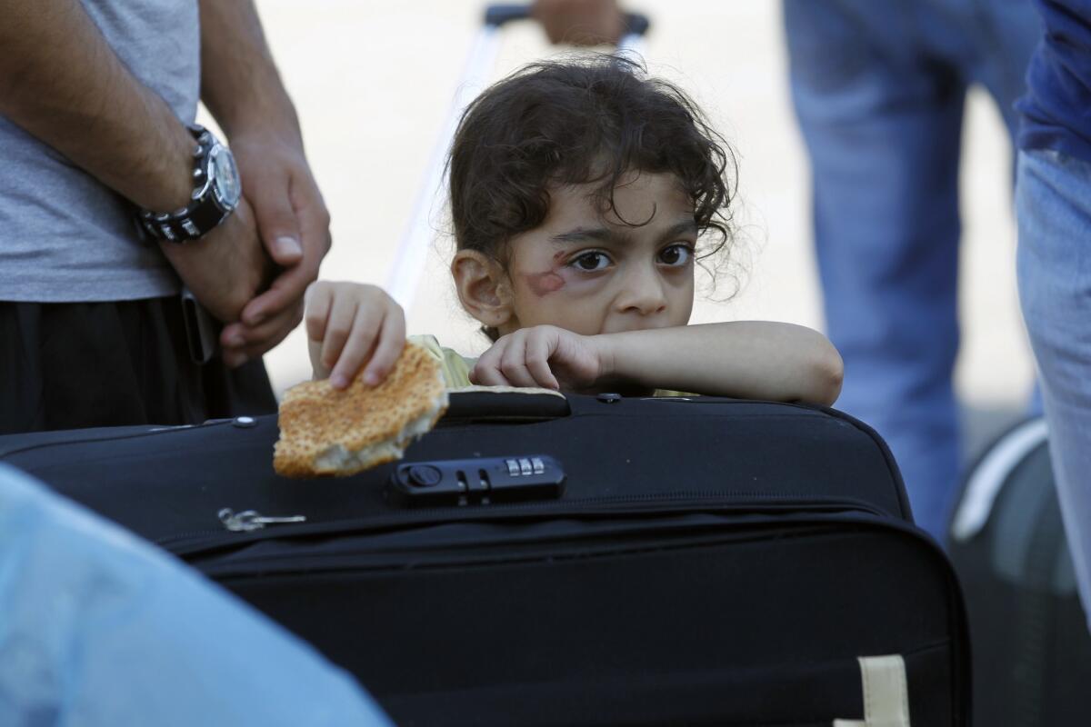 A Palestinian girl waits at the Rafah border terminal in the southern Gaza Strip to cross into neighboring Egypt after the crossing was opened for humanitarian reasons.