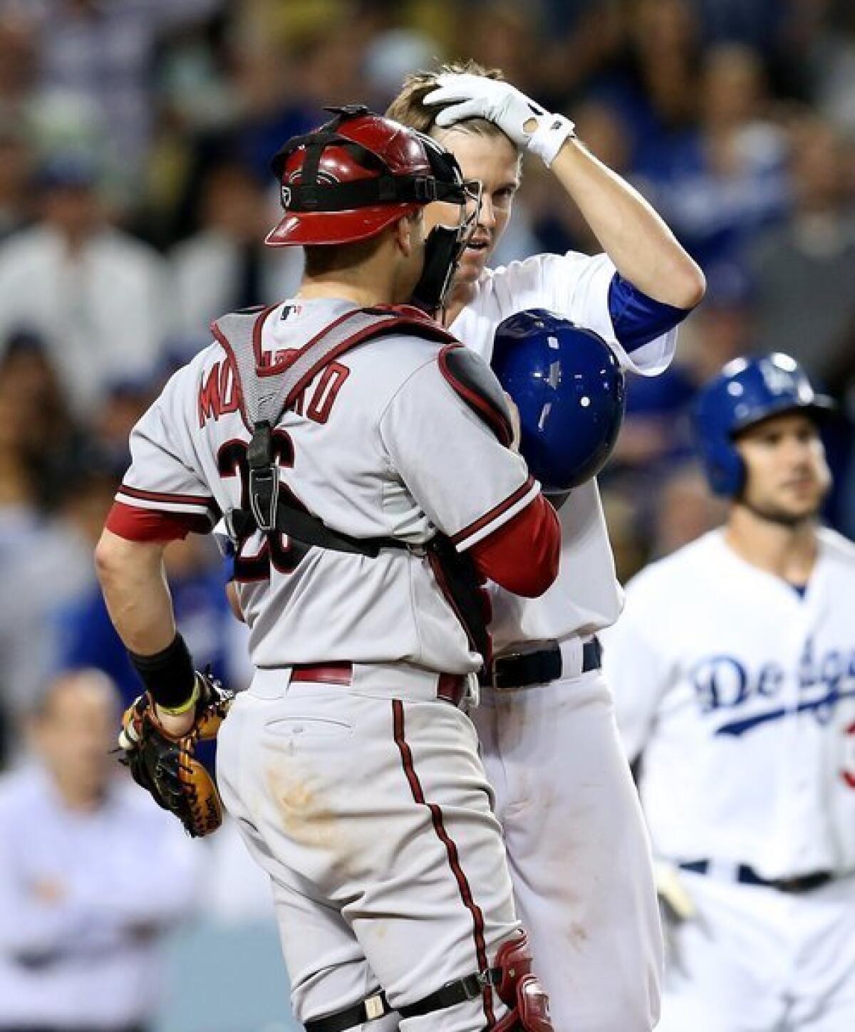 Zack Greinke and Miguel Montero talk at the plate after the Dodgers' starter was hit by an Ian Kennedy pitch in the seventh inning of the Dodgers' 5-3 victory over the Diamondbacks.