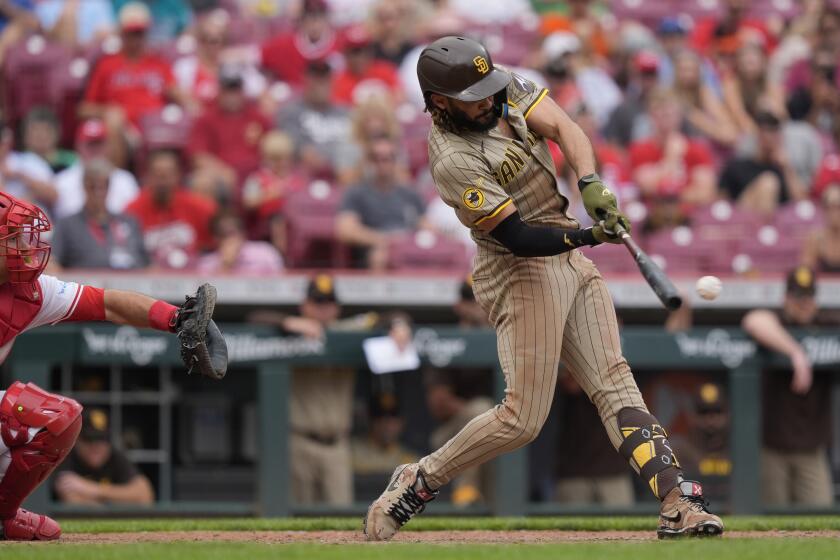 San Diego Padres' Fernando Tatis Jr. doubles to drive in Luis Campusano and advance Luis Arraez to third base in the 10th inning of a baseball game against the Cincinnati Reds, Thursday, May 23, 2024, in Cincinnati. The Padres won 6-4 in 10 innings. (AP Photo/Carolyn Kaster)