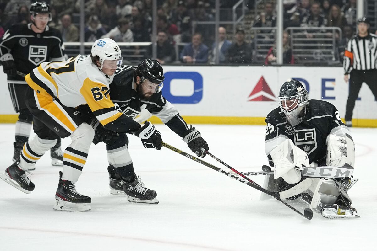 The Penguins' Rickard Rakell, left, is unable to get a shot past Kings goalie Pheonix Copley on Feb. 11, 2023.