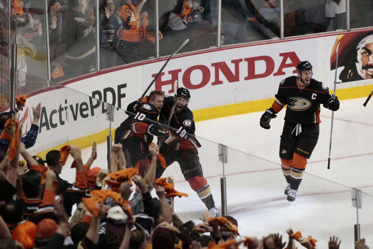 The Ducks celebrate Corey Perry's game-winning goal in overtime to give Anaheim a series victory over the Calgary Flames, 4-1, and advance to the Western Conference finals.