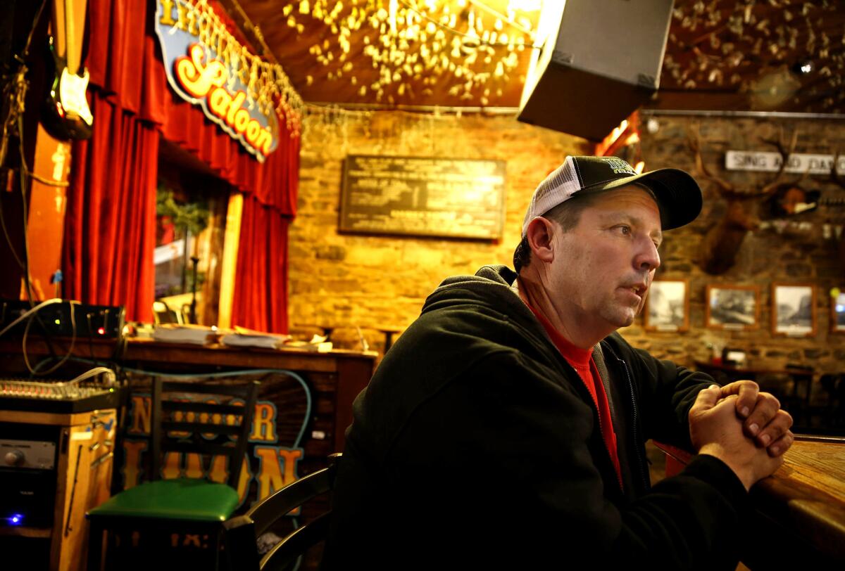 Rick Martinez, a Caltrans worker, sits at the bar of the Iron Door Saloon in Groveland, Calif., on Dec. 19, 2013. Martinez says he worked 14-hour days to keep California 120 open for firefighters during the massive Rim wildfire that burned from August to October 2013.