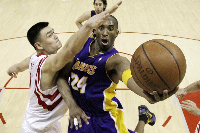 Los Angeles Lakers' Kobe Bryant (24) goes up for a shot as Houston Rockets' Yao Ming (11), of China, defends during the fourth quarter of a NBA basketball game Wednesday, March 11, 2009 in Houston. The Lakers beat the Rockets 102-96. (AP Photo/David J. Phillip)