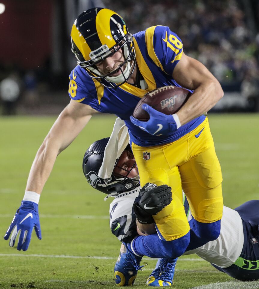 LOS ANGELES, CA, SUNDAY, DECEMBER 8, 2019 - Los Angeles Rams wide receiver Cooper Kupp (18) slips the tackle of Seattle Seahawks linebacker Cody Barton (57) after a catch near the goal line on a second quarter touchdown drive at LA Memorial Coliseum. (Robert Gauthier/Los Angeles Times)