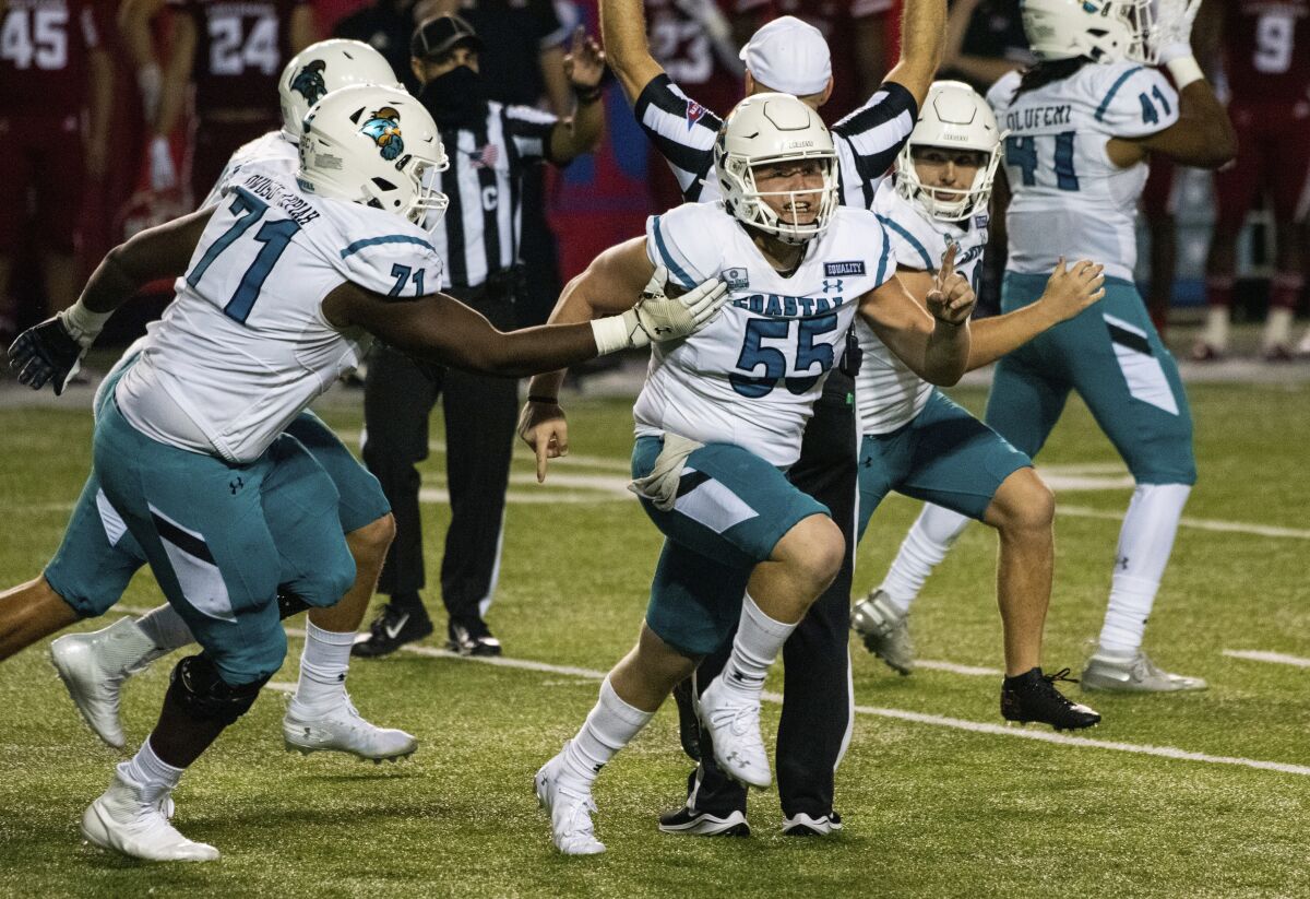 Coastal Carolina players celebrate after place kicker Massimo Biscardi (29) kicked the go-ahead and eventual game-winning field goal during the second half of an NCAA college football game against Louisiana-Lafayette in Lafayette, La., Wednesday, Oct. 14, 2020. (AP Photo/Paul Kieu)