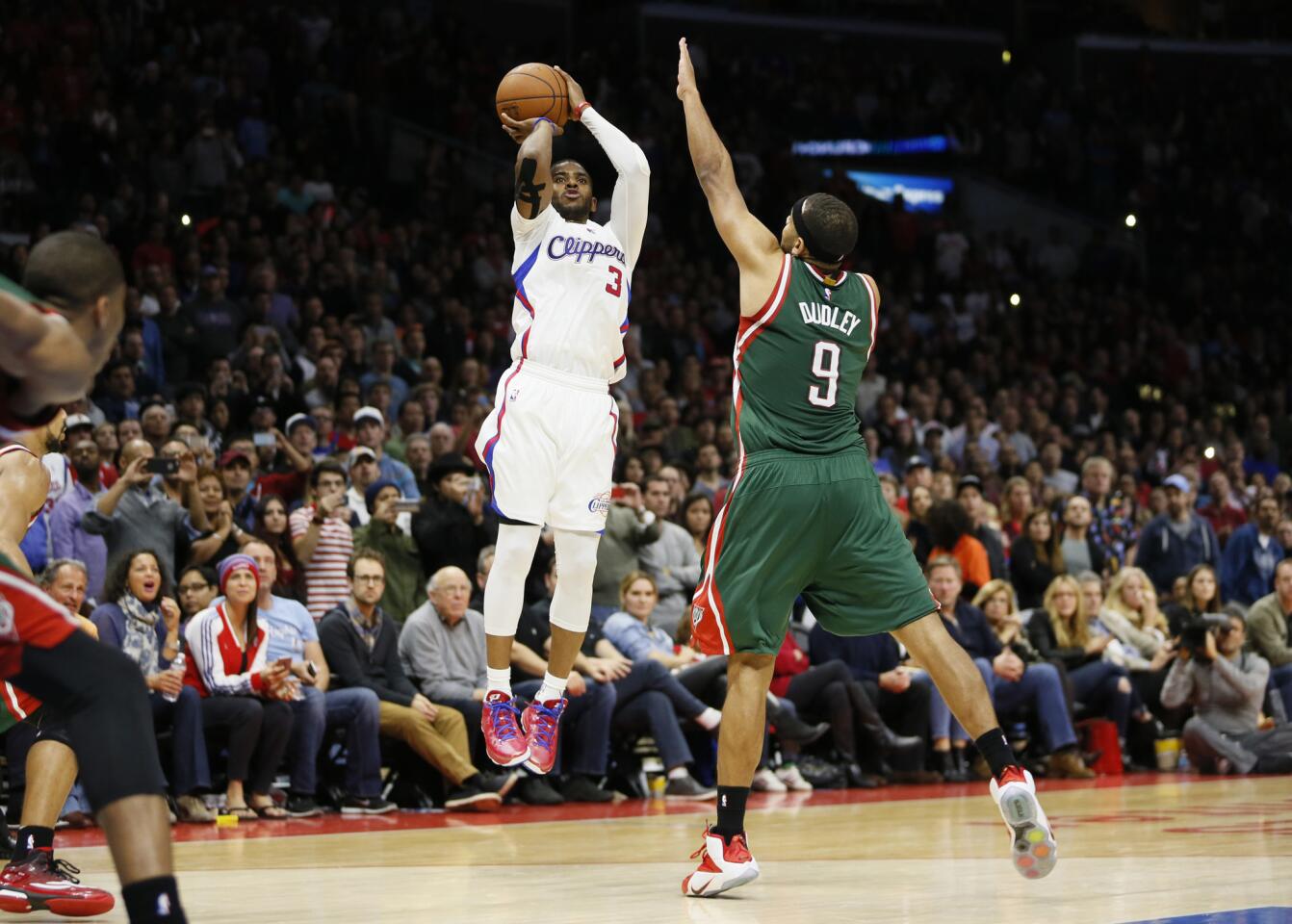 Chris Paul shoots over Milwaukee's Jared Dudley during the Clippers' 106-102 victory Saturday at Staples Center.