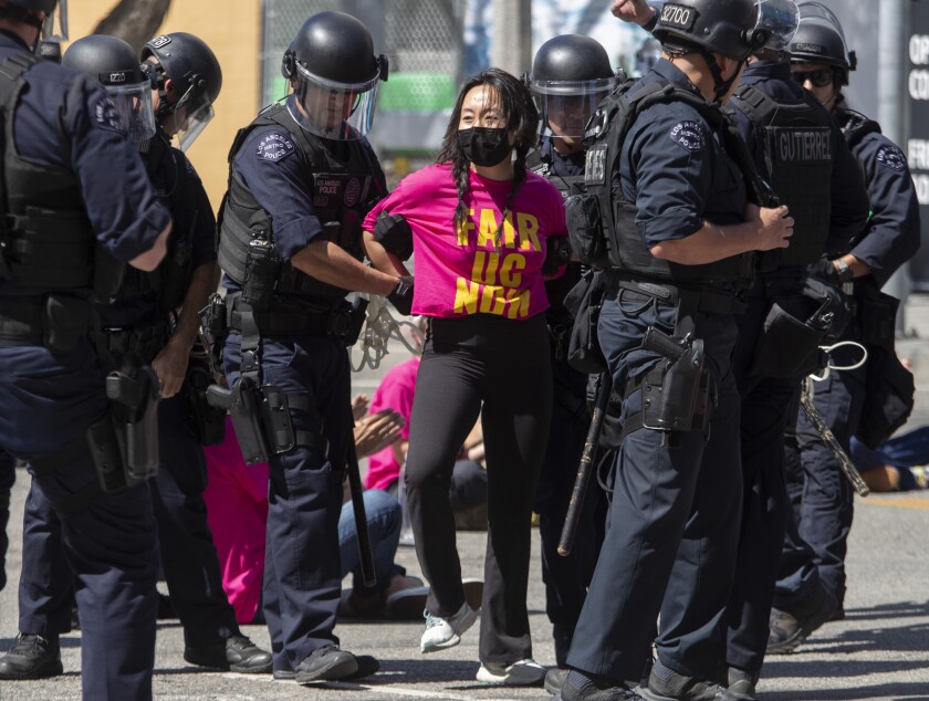 A protesters is arrested by police