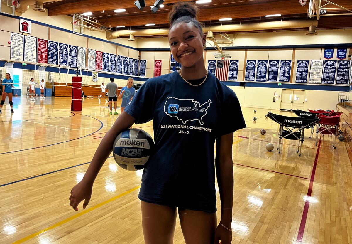 Marymount High outside hitter Torrey Stafford poses for a photo with volleyball tucked under her right arm.