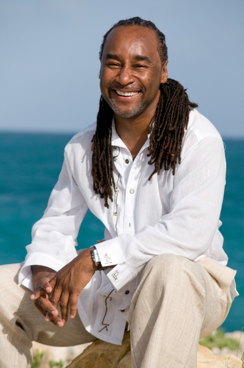 Eric Jerome Dickey smiling on a beach