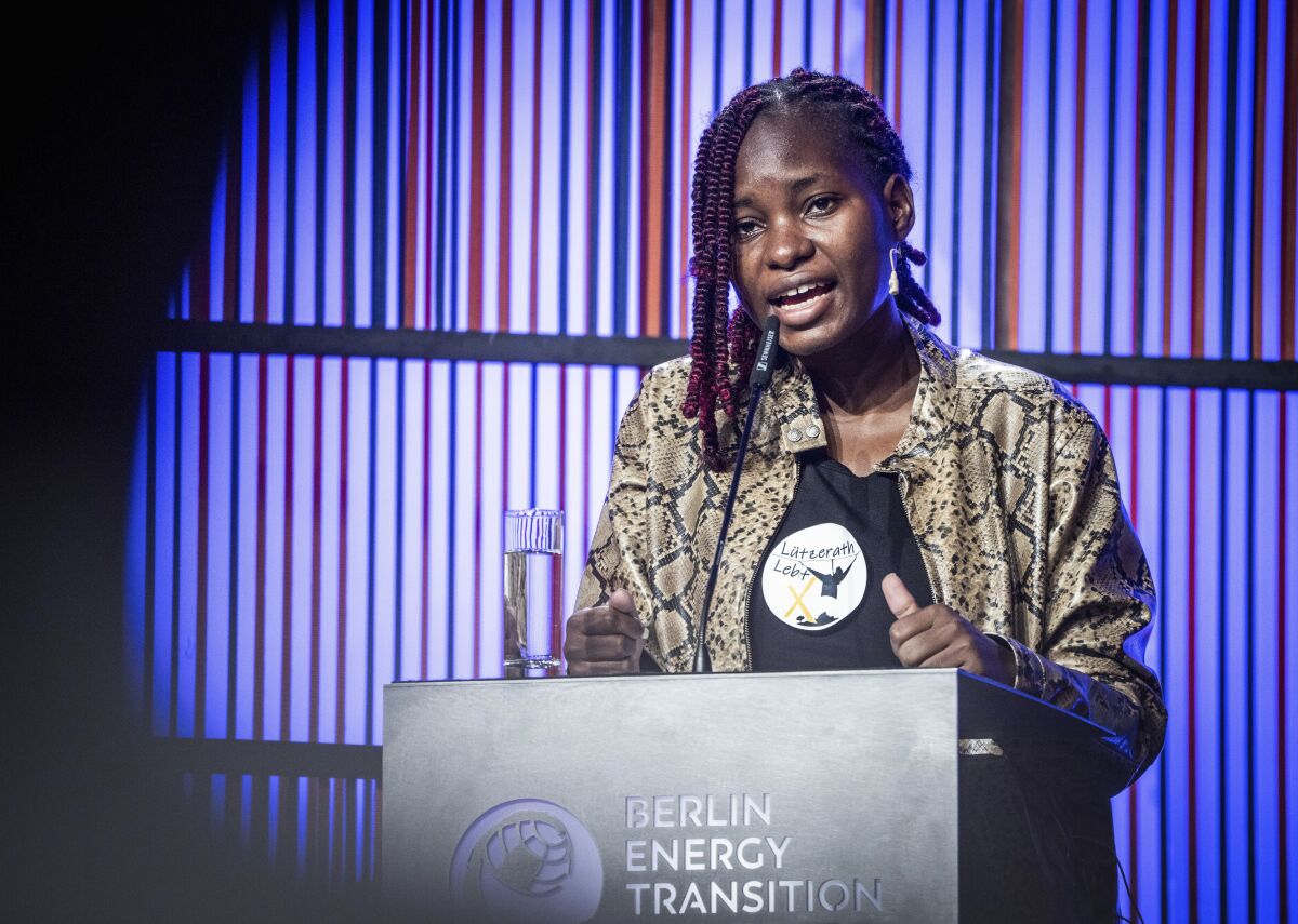 FILE - Hilda Nakabuye, Fridays for Future activist from Uganda, speaks at the opening of the Berlin Energy Transition Dialogue at the Federal Foreign Office in Berlin, March 29, 2022. Climate activists are urging more banks and insurers not to back the controversial $5 billion East African Crude Oil Pipeline that is primed to transport oil from the Hoima oilfields in Uganda to the Tanzanian coastal city of Tanga. Influential climate activists Vanessa Nakate and Hilda Nakabuye have lent their support to opponents of the pipeline citing the need for Africa to stay away from fossil fuels. (Michael Kappeler/dpa via AP, file)