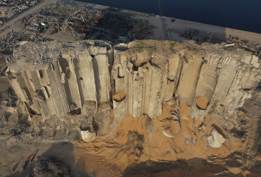 FILE - Rubble and debris are seen around the silo that was destroyed by a massive explosion that hit the seaport of Beirut, in Beirut, Lebanon, Aug. 29, 2020. Lebanon's government on Thursday, April 14, 2022, approved the demolition of Beirut's grain silos, which were gutted by the devastating 2020 explosion at Beirut's port which killed 216 people and ravaged parts of the capital. (AP Photo/Hussein Malla, File)