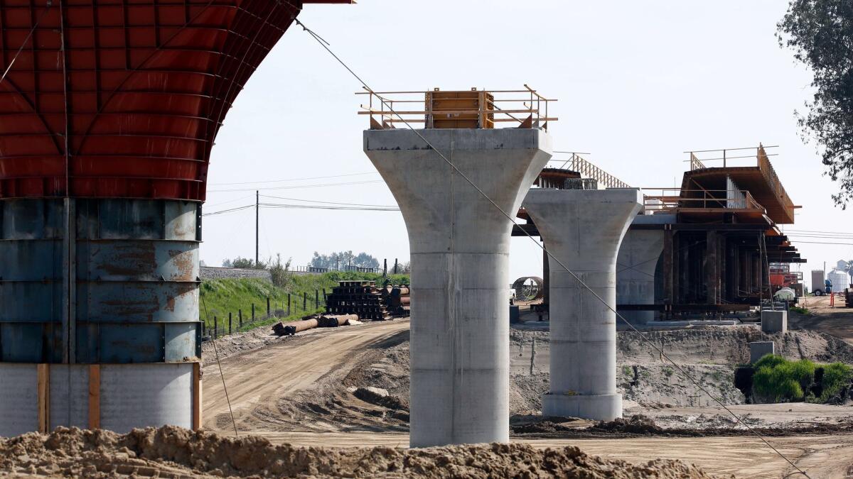 Supports for a viaduct to carry high-speed rail trains across the Fresno River stand under construction near Madera, Calif., in 2016.