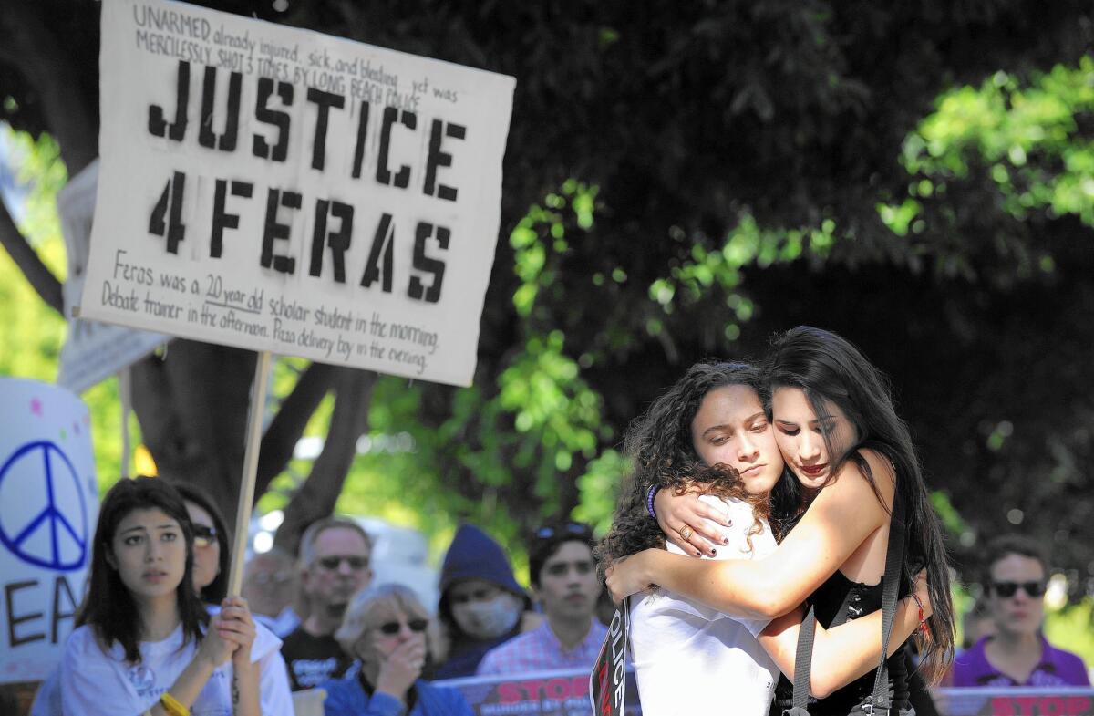 At a demonstration in Long Beach over the shooting death of Feras Morad, his sister, Ghada Morad, 16, second from right, is hugged by Sonia Hernandez, whose brother was killed by Anaheim police in 2012.