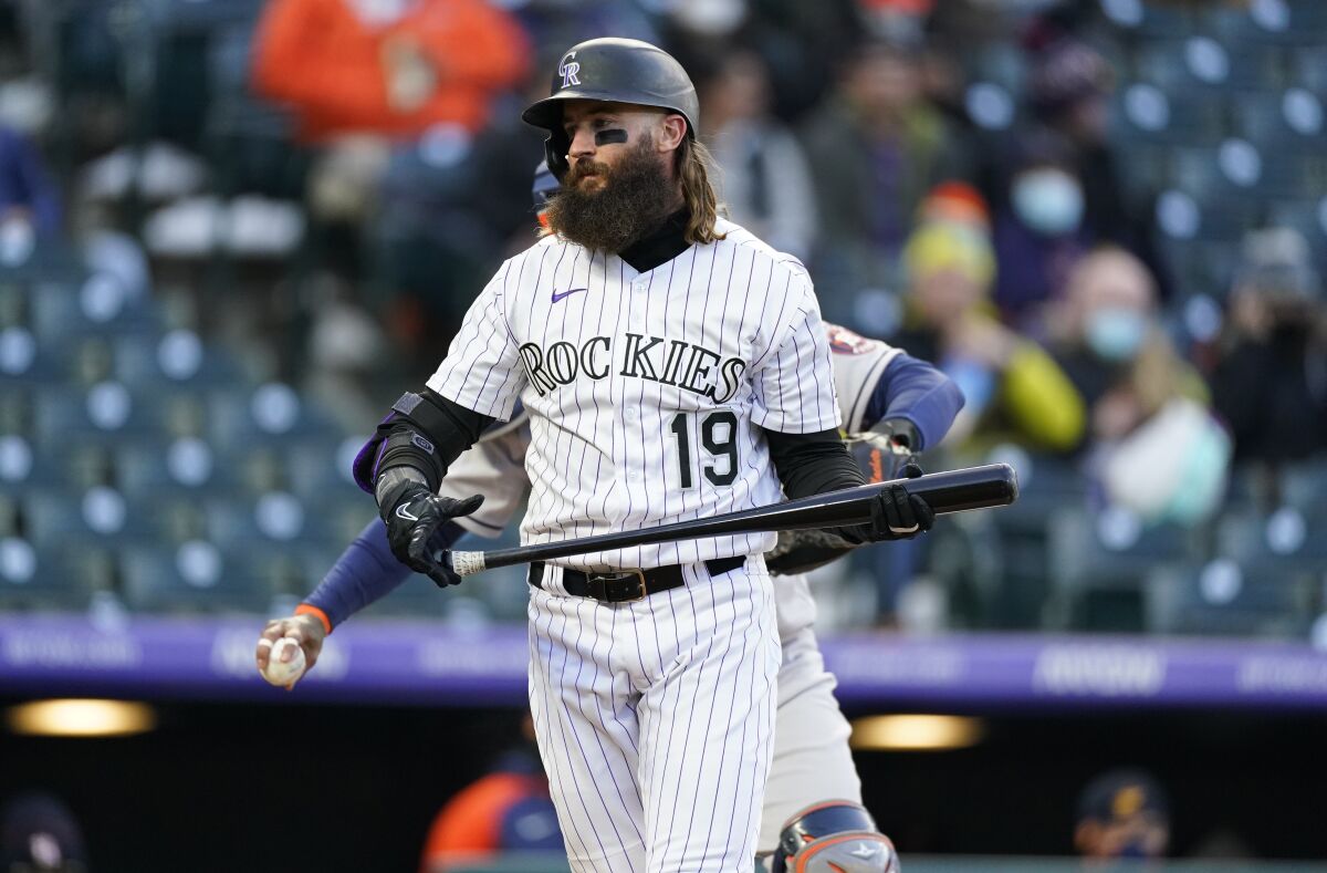 Colorado Rockies' Charlie Blackmon heads back to the dugout after striking out against Houston Astros starting pitcher Luis Garcia during the second inning of a baseball game Tuesday, April 20, 2021, in Denver. (AP Photo/David Zalubowski)