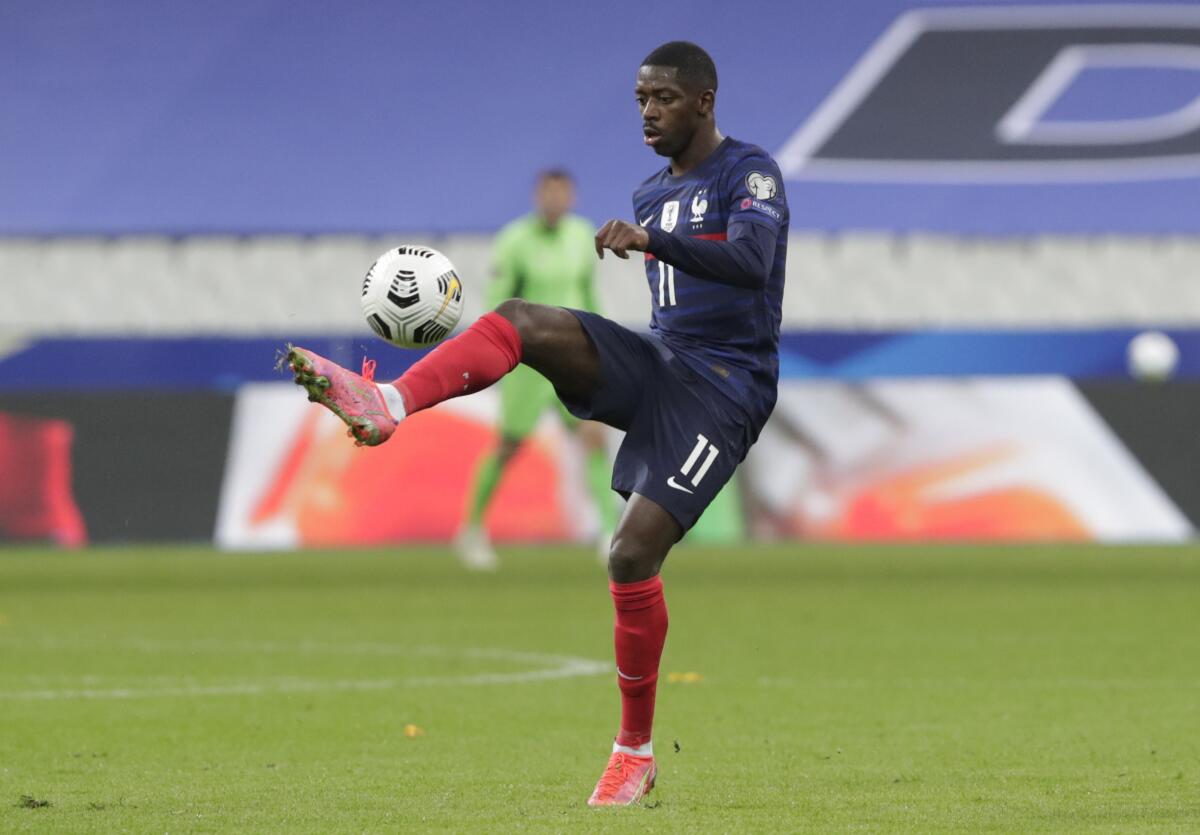 FILE - In this file photo dated Wednesday, March 24, 2021, France's Ousmane Dembele controls the ball during the World Cup 2022 soccer match against Ukraine at the Start de de France stadium, in Saint Denis, north of Paris. At first criticized for not fitting into Barcelona’s passing style, Dembele is now credited with diversifying Barcelona’s attack with his solo efforts and unbridled confidence to shoot from long range.(AP Photo/Thibault Camus, FILE)