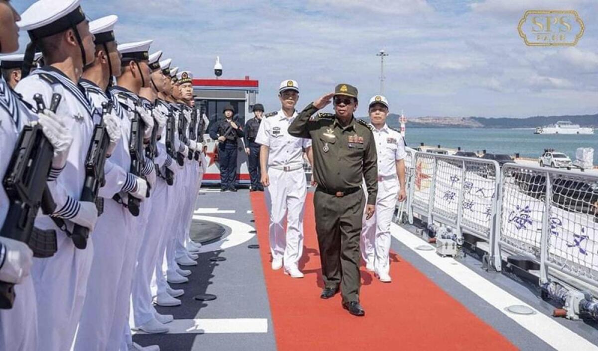 Former Cambodian Defense Minister reviewing navy members