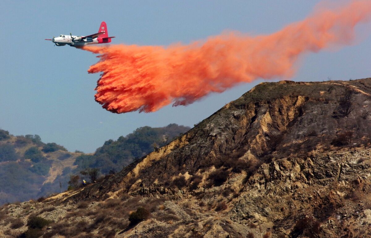 A P-2V drops retardant on the Madre fire in the Angeles National Forest above Azusa.