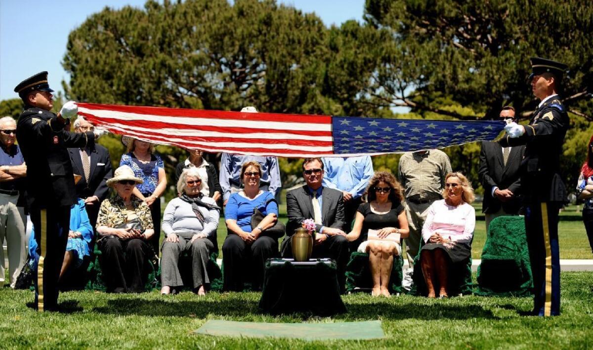 Mike Watts, center, and his family at his father's service at Los Angeles National Cemetery on Thursday.