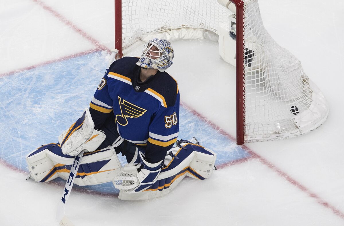 St. Louis Blues goalie Jordan Binnington reacts after giving up a goal to the Vancouver Canucks during the third period in Game 1 of an NHL hockey Stanley Cup first-round playoff series, Wednesday, Aug. 12, 2020, in Edmonton, Alberta. (Jason Franson/The Canadian Press via AP)