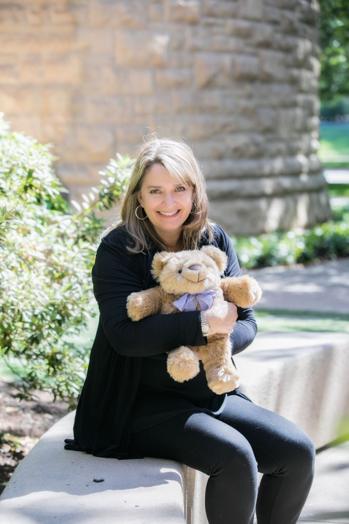 Marcella Johnson holds The Comfort Cub, a weighted therapeutic teddy bear.