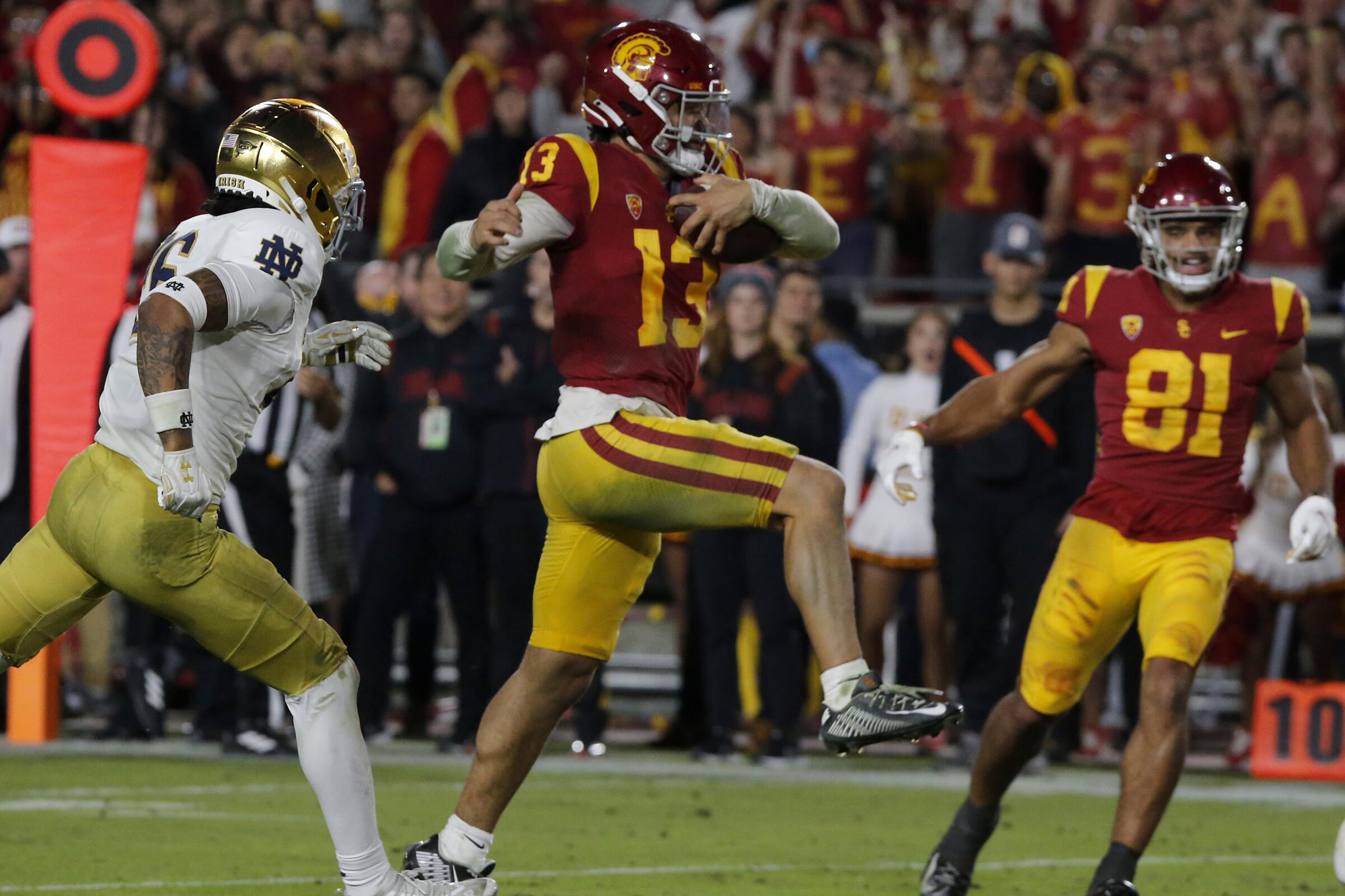 USC quarterback Caleb Williams leaps into the end zone for a touchdown against Notre Dame.