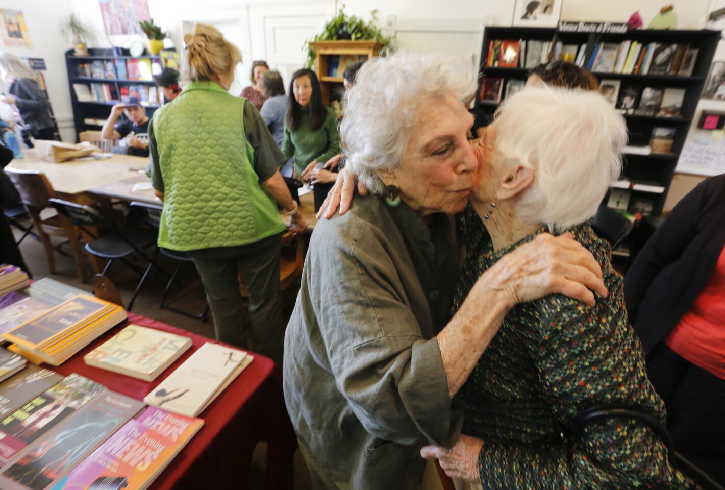 Esther Morrison and Selma Benjamin hug each other at the end of meeting of the Green Poets of Venice. The group has been meeting at the Beyond Baroque art center on Tuesday mornings for the past 14 years.