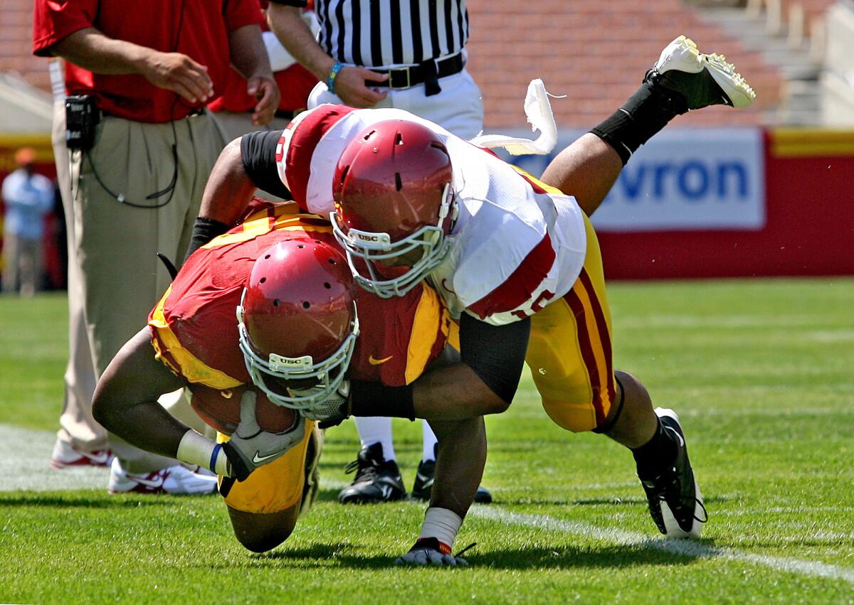 USC's Hayes Pullard tackles Xavier Grimble during the 2011 Spring game. The NCAA's new safety guidelines recommends less contact in football practices.