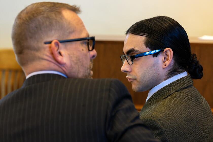 SANTA ANA, CA - JANUARY 18: Senior deputy public defender Randall Bethune, left, and Marcus Anthony Eriz, a Costa Mesa man accused of killing a 6-year-old Aiden Leos in a road-rage, at the start of the trial in Dept. 45 Central Courthouse on Thursday, Jan. 18, 2024 in Santa Ana, CA. (Irfan Khan / Los Angeles Times)