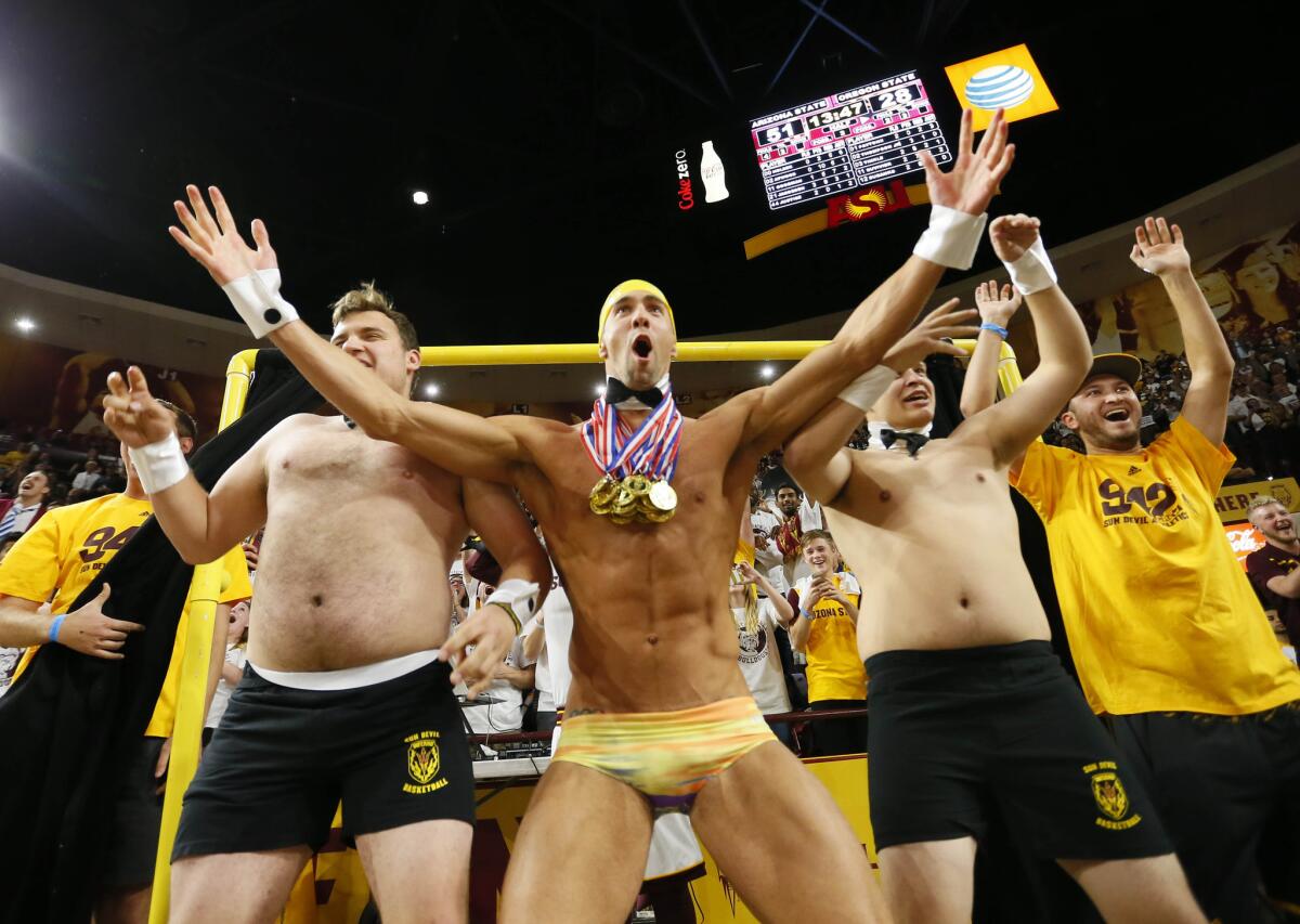 Olympic swimmer Michael Phelps, center, takes part in Arizona State's Curtain of Distraction during an Oregon State free throw on Thursday night.