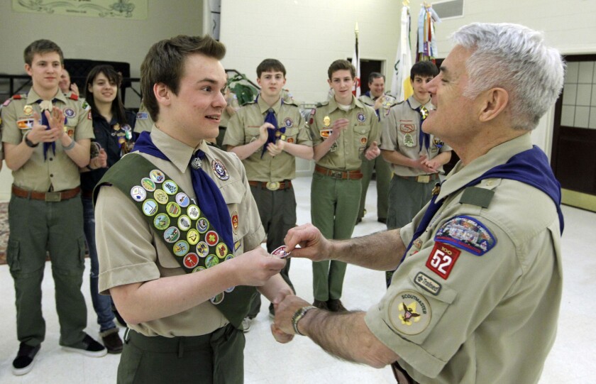 Pascal Tessier, left, receives his Eagle Scout badge from Troop 52 Scoutmaster Don Beckham on Monday in Chevy Chase, Md. Tessier became the first openly gay scout to reach the highest rank since a policy change to allow gay youth in the Boy Scouts of America.