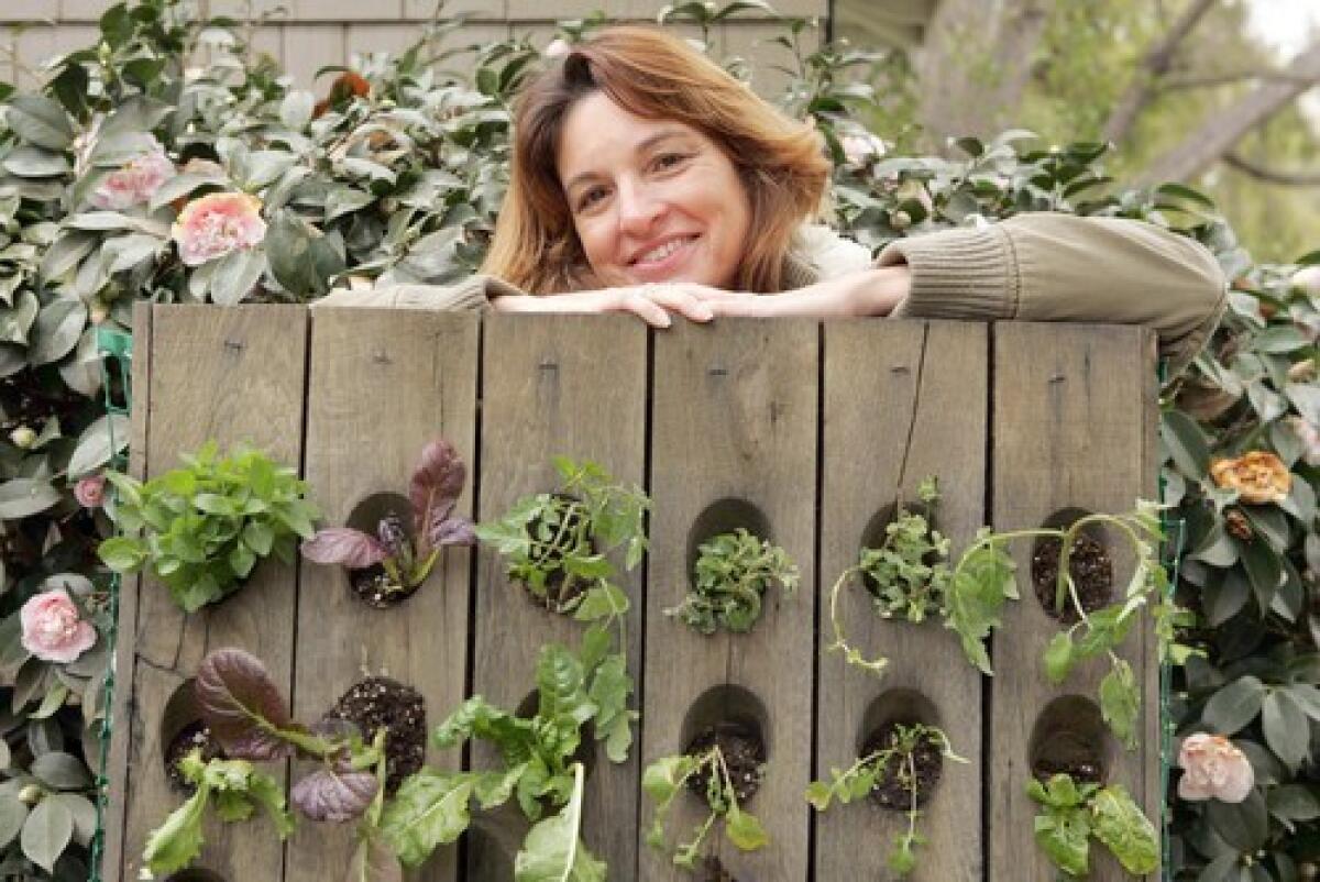 Garden designer Anne Phillips with her edible plant wall.